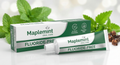 Maplemint fluoride-free toothpaste and packaging with mint leaves in the background